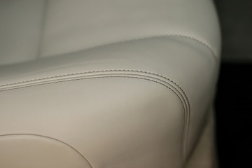 Modern car interior detail. Leather seat with stich. - obrazy, fototapety, plakaty