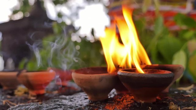 Spiritual background of burning candles in Buddhist temple. Flames and fumes of aromatic oil in South East Asia