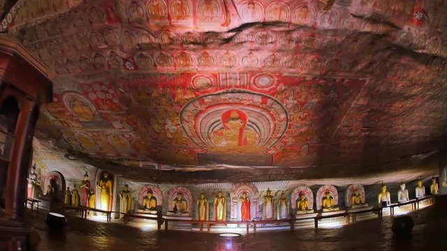 Dambulla cave temple or Golden Temple of Dambulla Sri Lanka World Heritage Site. Camera enters inside ancient Buddhist complex with beautiful sculptures, wall painting and religious decorations