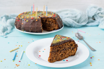 Chocolate cake slice with chocolate icing for birthday