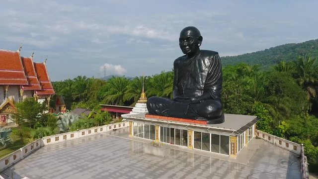 Aerial: Black Monk Statue At Buddhism Temple in Phang Nga Province. Popular Touristic Place Birds Eye Drone View. HD.
