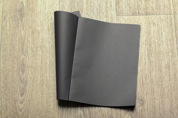 Mockup of black paper on wooden table
