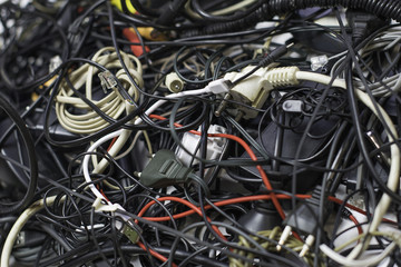 a bunch of tangled wires, connectors and cables