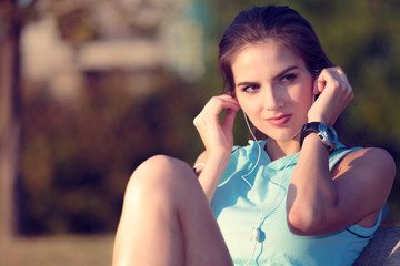 Woman listening to music with earphones from her smart phone