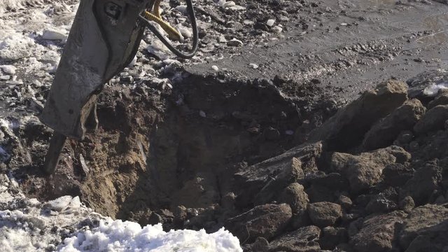Breaker (hydraulic) cuts frozen soil stock footage video
