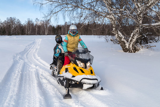 Man and woman on a snowmobile.