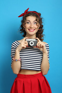  woman with retro camera, wearing pin-up style