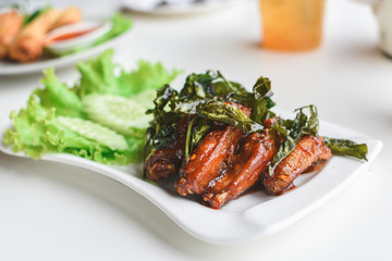 Fried chicken wing in white plate.
