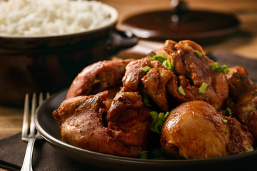 Chicken pieces baked in tomato sauce and boiled rice.