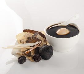Chinese traditional herbs and medicine soup on background.