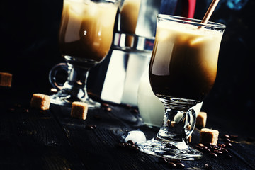 Ice coffee in glasses on a dark background, selective focus