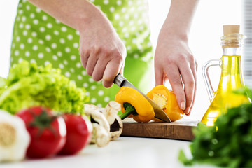 Woman hands cutting vegetables in the kitchen