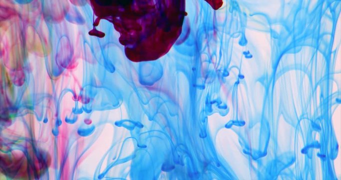 Red ink mixing with blue creating amazing abstract background