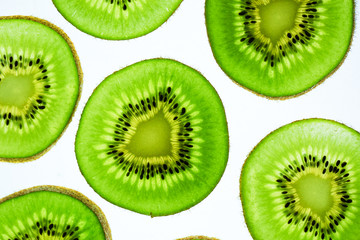 Fototapeta premium Still life picture, Abstract fruit background is close up on Kiwi slice, to show a detail on fresh kiwi face with white background
