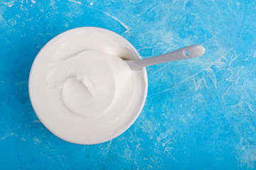 Yogurt on blue background. Dairy product. Healthy food and diet concept. Copy space. Top view
