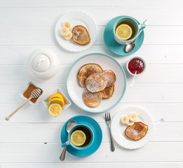 breakfast with pancakes, tea with lemon, topview