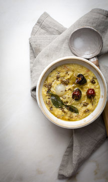 Indian lentil soup / Dal fry on a marble table