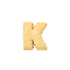 Closeup brown biscuit in K english alphabet isolated on white background with clipping path