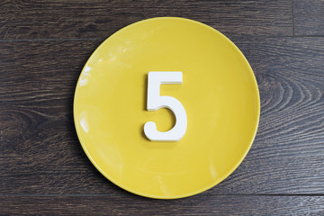 Figure five on the yellow plate.