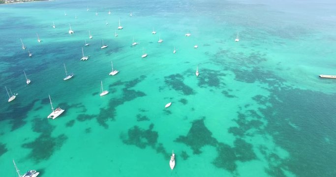 Aerial view of Sailboats docking on blue caribbean sea