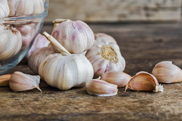 Garlic Cloves and Garlic Bulb on old table