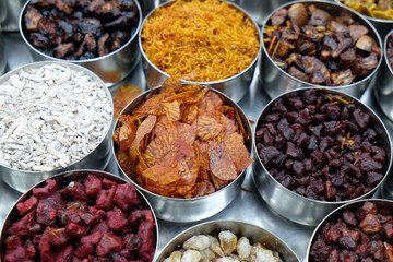 Different spices and herbs in metal bowls on a street market in Kolkata, West Bengal, India 
