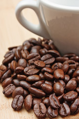 coffee beans and cup on wooden background