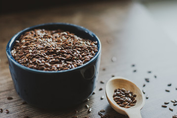 Bowl full of brown flaxseed or linseed. Cereals. Vitamins. Healthy food.