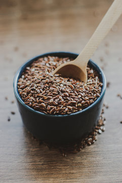 Bowl full of brown flaxseed or linseed. Cereals. Vitamins. Healthy food.