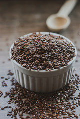 Bowl full of brown flaxseed or linseed. Cereals. Vitamins. Healthy food.