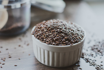 Bowl full of brown flaxseed or linseed. Cereals. Vitamins. Healthy food.