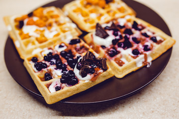 Wafers with chocolate, cloudberries, blueberries and ice cream. Needlework.