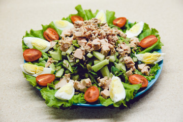 Salad with cucumber, boiled egg, tomato, cod liver, avocado, arugula. Fresh and healthy. Dietary food is prepared at home. Raw.