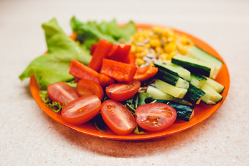 Sliced vegetables for breakfast. Healthy food. Corn, salad, pepper, tomato, cucumber, pumpkin seeds.
