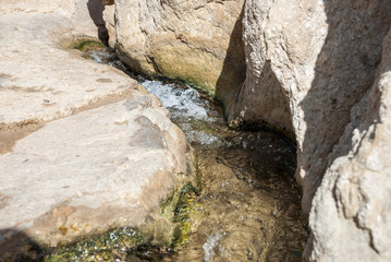 The beginning of a river with clear water in the desert