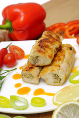 Chicken rolls stuffed with feta cheese and vegetables.