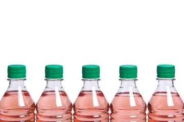 Plastic bottles with green lids and pink liquid inside on a white background