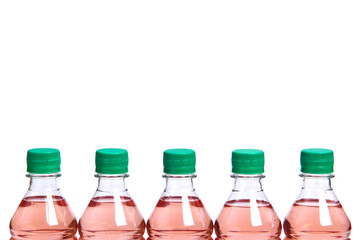 Plastic bottles with green lids and pink liquid inside on a white background