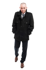 Full body of middle age business man walking wearing overcoat