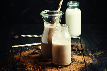 Chocolate milk in bottles, selective focus