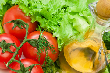 Tomato, lettuce salad and jug of vegetable oil