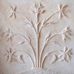 Mughal stone art on the facade of the Taj Mahal (Crown of Palaces), an ivory-white marble mausoleum...