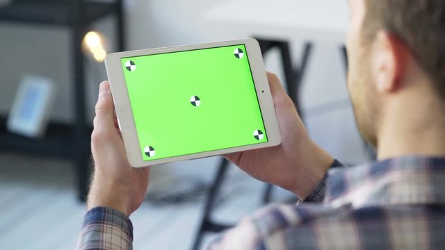 Businessman holds in hands close up and uses device with touch green screen for reading press or social networks closeup. Information accessibility with smart devise