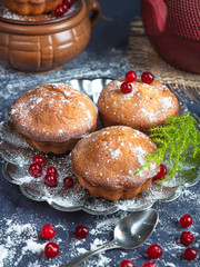 Fresh homemade muffins baking with berries cranberries on a blue background, cozy festive style