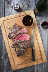 Barbecue dry aged Rib of Beef as close-up on a cutting board
