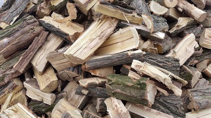 Throwing firewood on a pile. Stack with firewood.