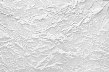 Surface of crumpled paper highlighted by light.
Stressed, illuminated sheet of paper paper.