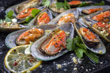 Baked Green Shell Mussels on old rustic Sheet