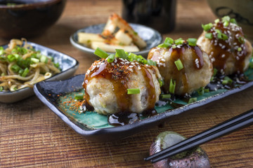 Traditional Japanese Takoyaki with Sprouts and Daikon on a plate