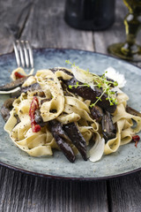 Traditional ITalian Pappardelle alla Melanzane as close-up on a Plate